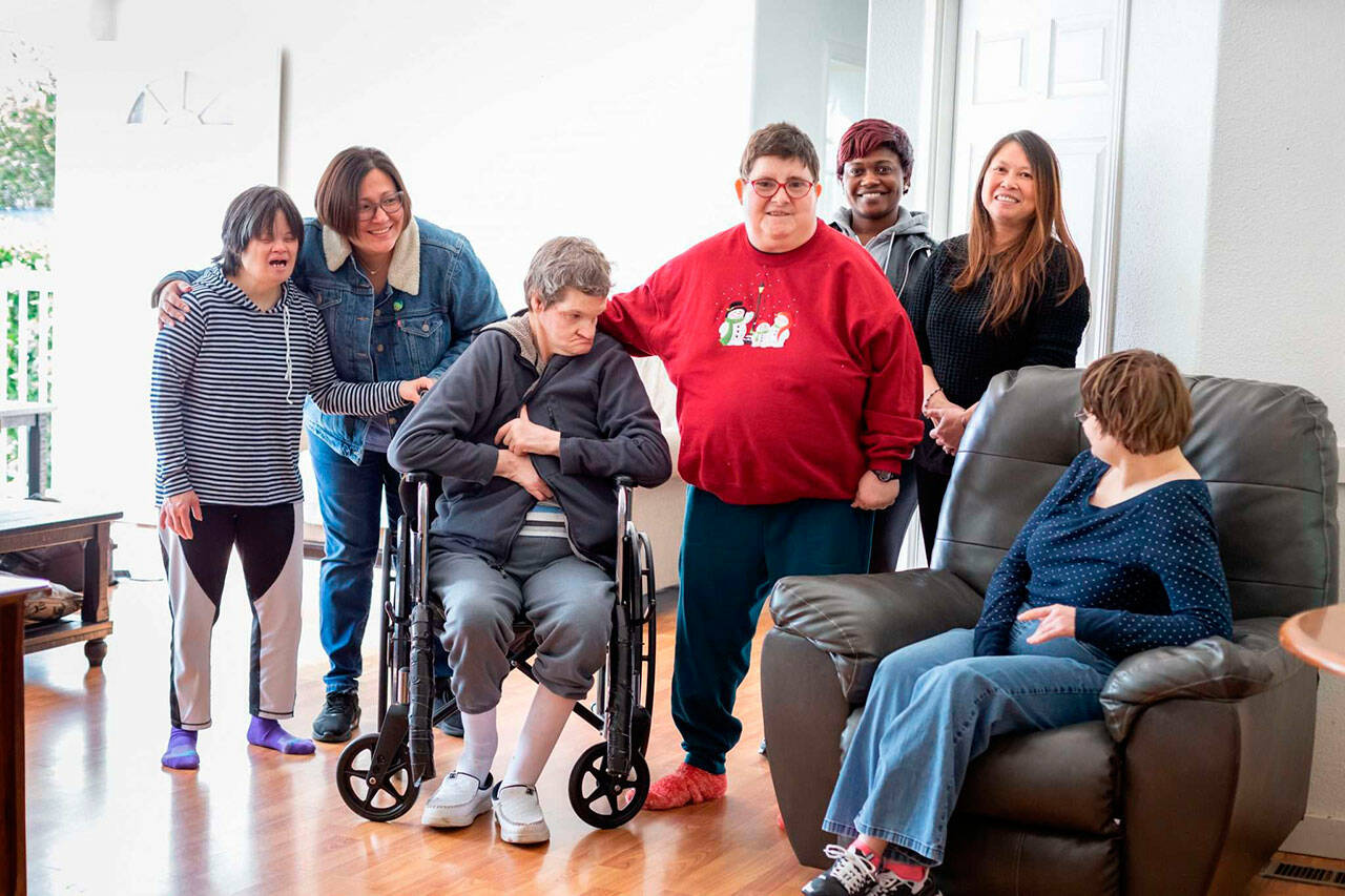 Clients and staff of an Alpha Supported Living Services facility gather for a photo. (Alpha Supported Living Services)