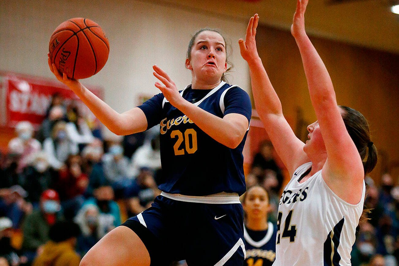 Everett’s Ella Sylvester hits a difficult hook shot against Arlington Tuesday, Feb. 15, 2022, at Marysville Pilchuck High School in Marysville, Washington. (Ryan Berry / The Herald)