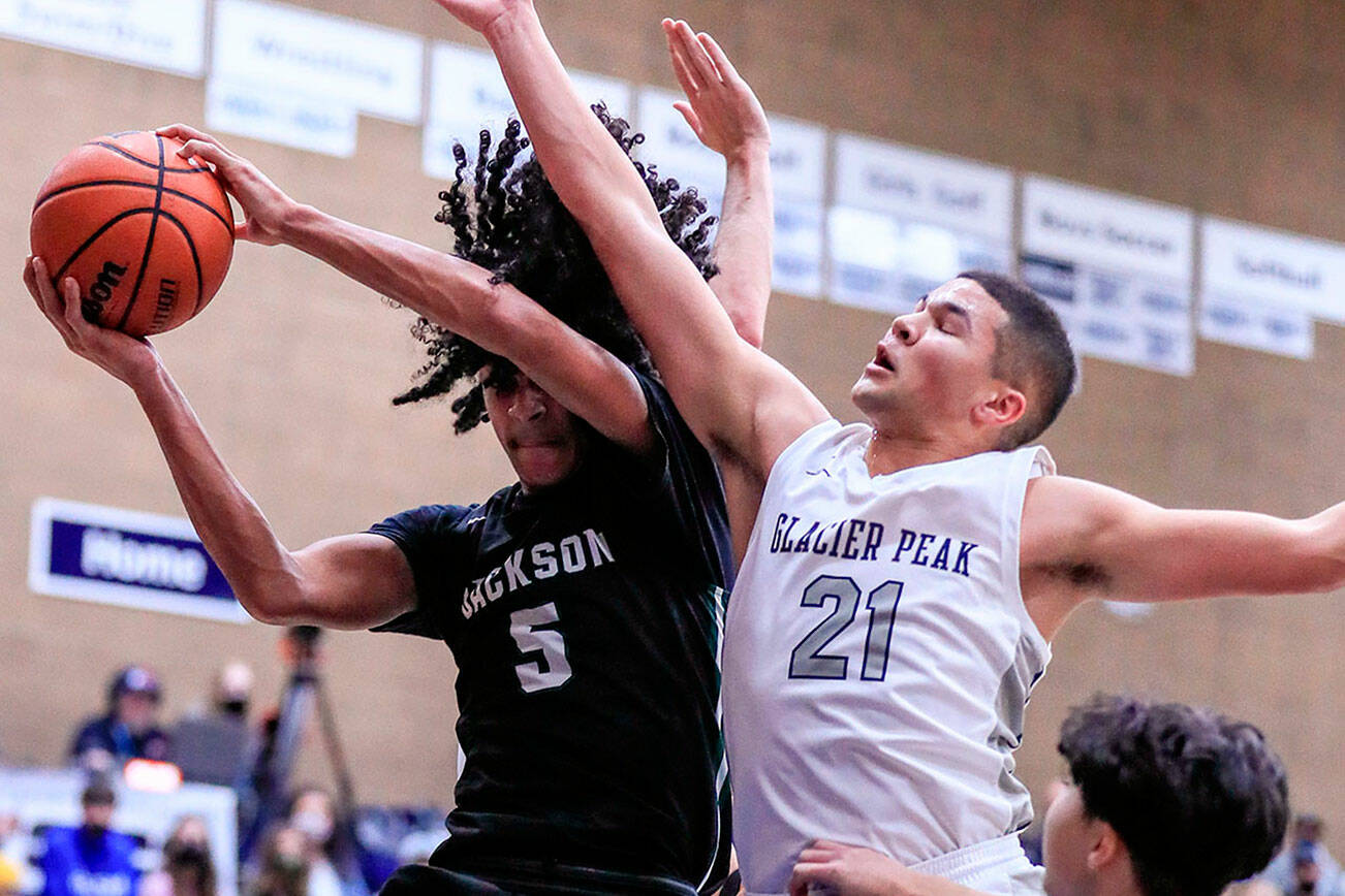 Jackson's Sylas Williams wins a rebound against Glacier Peak's Torey Watkins Friday evening at Glacier Peak High School in Snohomish, Washington on January 21, 2022. The Grizzles won 57-54. (Kevin Clark / The Herald)