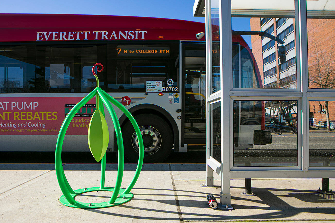 A public art bike rack is seen on the streets as a bus pulls up to a bus stop along Broadway Wednesday, Feb. 23, 2022, in downtown Everett, Washington. (Ryan Berry / The Herald)