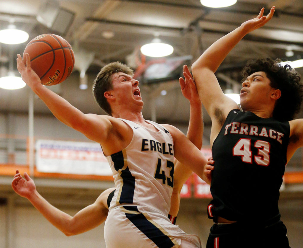 Don Brown defends a shot during the Hawks’ shutdown performance against Arlington in last week’s district semifinal. (Ryan Berry / The Herald)
