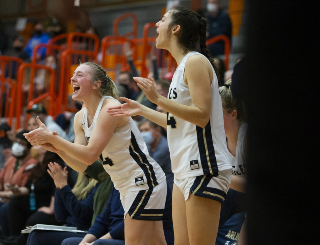 Arlington’s Keira Marsh and Jenna Villa cheer on their teammates. (Olivia Vanni / The Herald)
