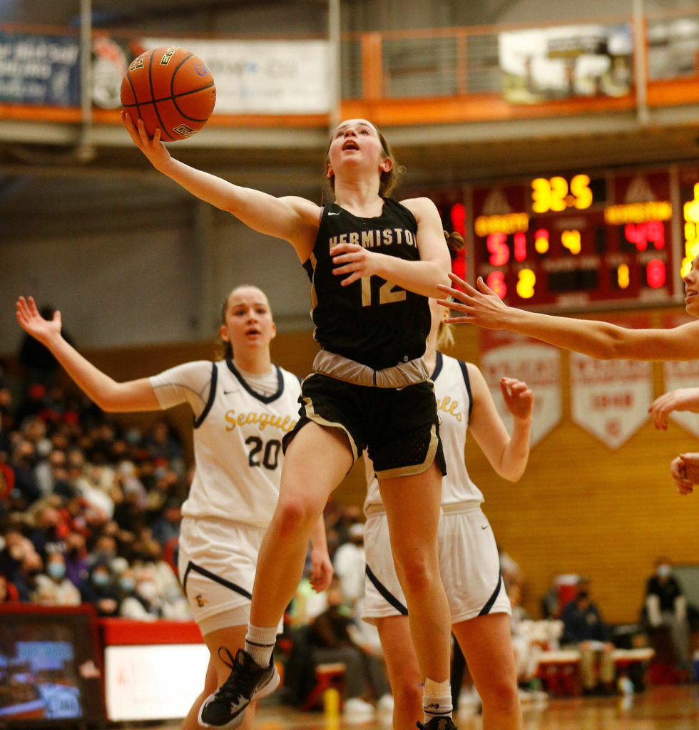 Hermiston’s Izzy Simmons puts in a late layup to tie the game against Everett Saturday, Feb. 26, 2022, during a Class 3A regional matchup at Everett Community College in Everett, Washington. (Ryan Berry / The Herald)
