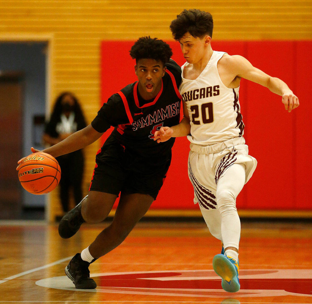 Sammamish’s Camayan Bell fights off a defender against Lakewood Saturday, Feb. 26, 2022, during a Class 2A regional matchup at Everett Community College in Everett, Washington. (Ryan Berry / The Herald)

