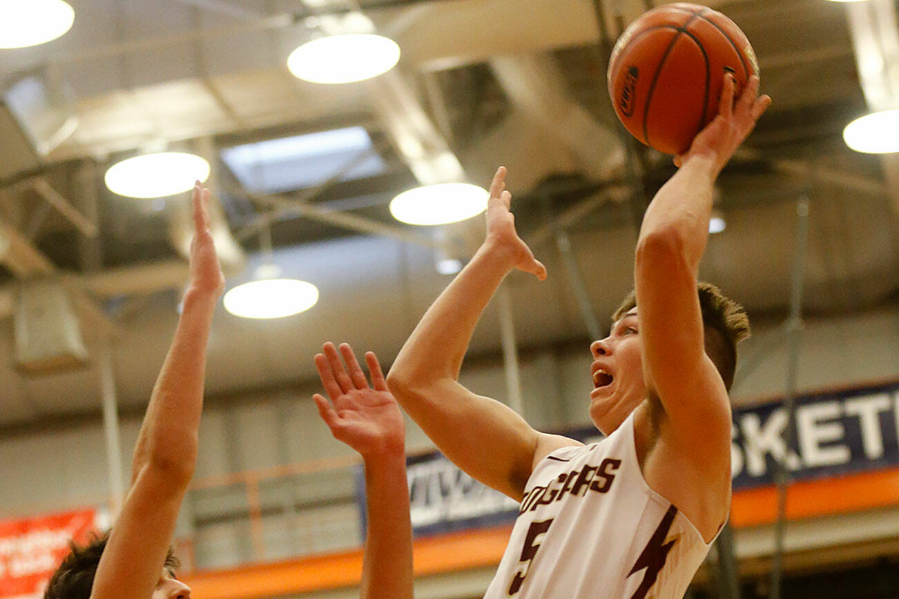 Lakewood’s Justice Taylor goes for an acrobatic layup against Sammamish Saturday, Feb. 26, 2022, during a Class 2A regional matchup at Everett Community College in Everett, Washington. (Ryan Berry / The Herald)