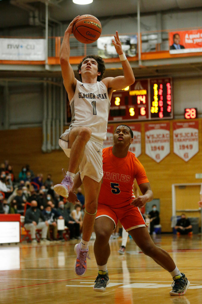 Glacier Peak’s Aidan Davis finishes off a fast break against Graham-Kapowsin Saturday, Feb. 26, 2022, during a Class 4A regional matchup at Everett Community College in Everett, Washington. (Ryan Berry / The Herald)
