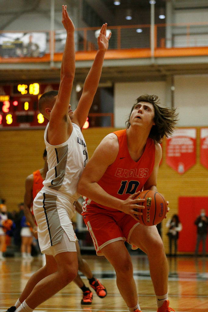 Graham-Kapowsin’s Gabriel Rzany turns to the basket before scoring against Glacier Peak Saturday, Feb. 26, 2022, during a Class 4A regional matchup at Everett Community College in Everett, Washington. (Ryan Berry / The Herald)
