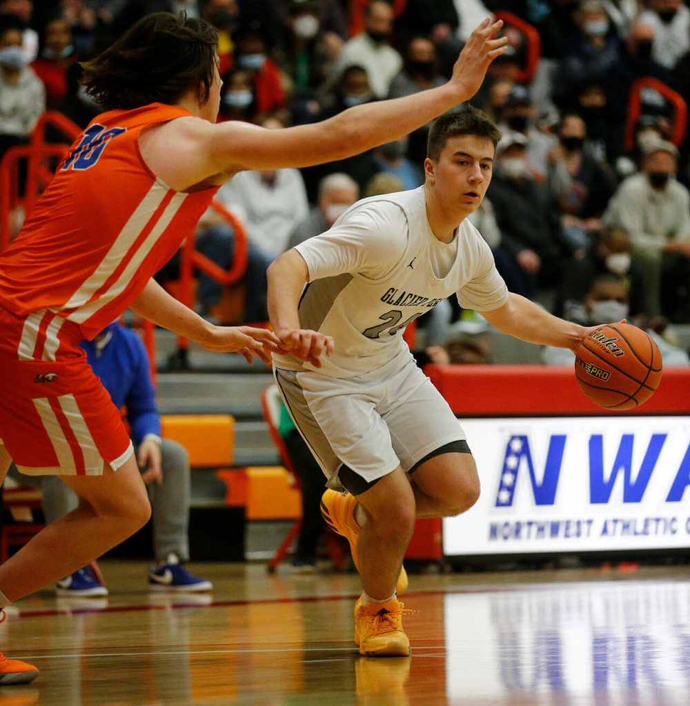 Glacier Peak’s Paxton Bigby dribbles toward the net against Graham-Kapowsin Saturday, Feb. 26, 2022, during a Class 4A regional matchup at Everett Community College in Everett, Washington. (Ryan Berry / The Herald)
