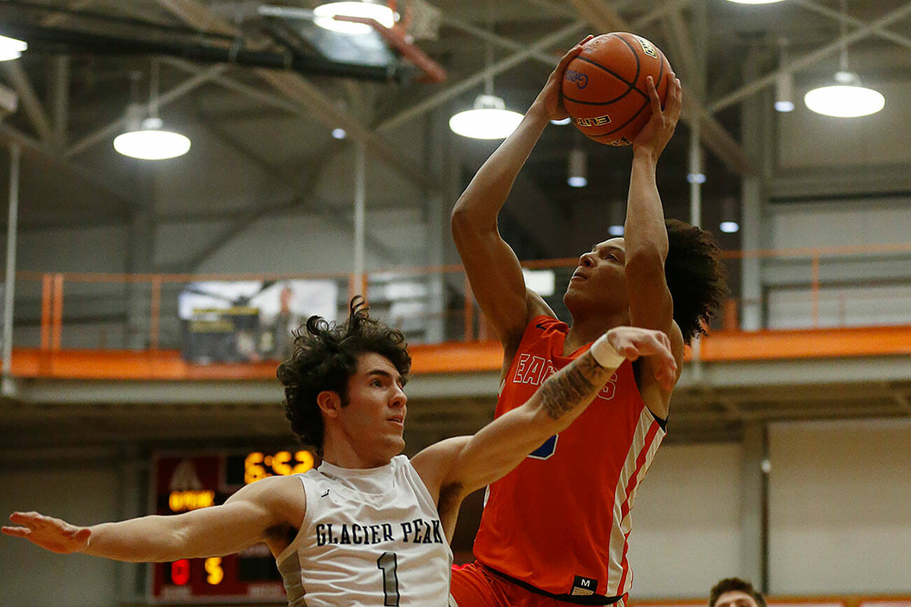 Graham-Kapowsin’s Joshua Wood scores over a defender against Glacier Peak Saturday, Feb. 26, 2022, during a Class 4A regional matchup at Everett Community College in Everett, Washington. (Ryan Berry / The Herald)