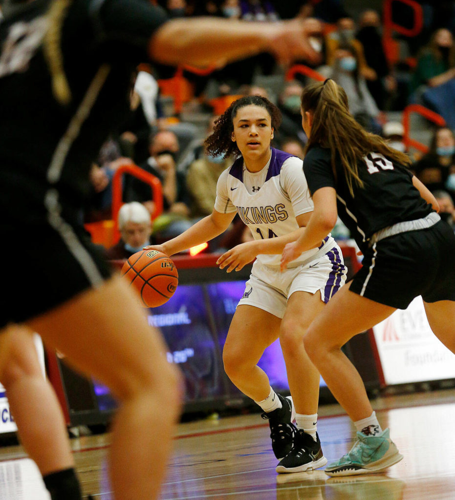 Lake Stevens’ Baylor Thomas takes the ball across the half court line against Eastlake Saturday, Feb. 26, 2022, during a Class 4A regional matchup at Everett Community College in Everett, Washington. (Ryan Berry / The Herald)
