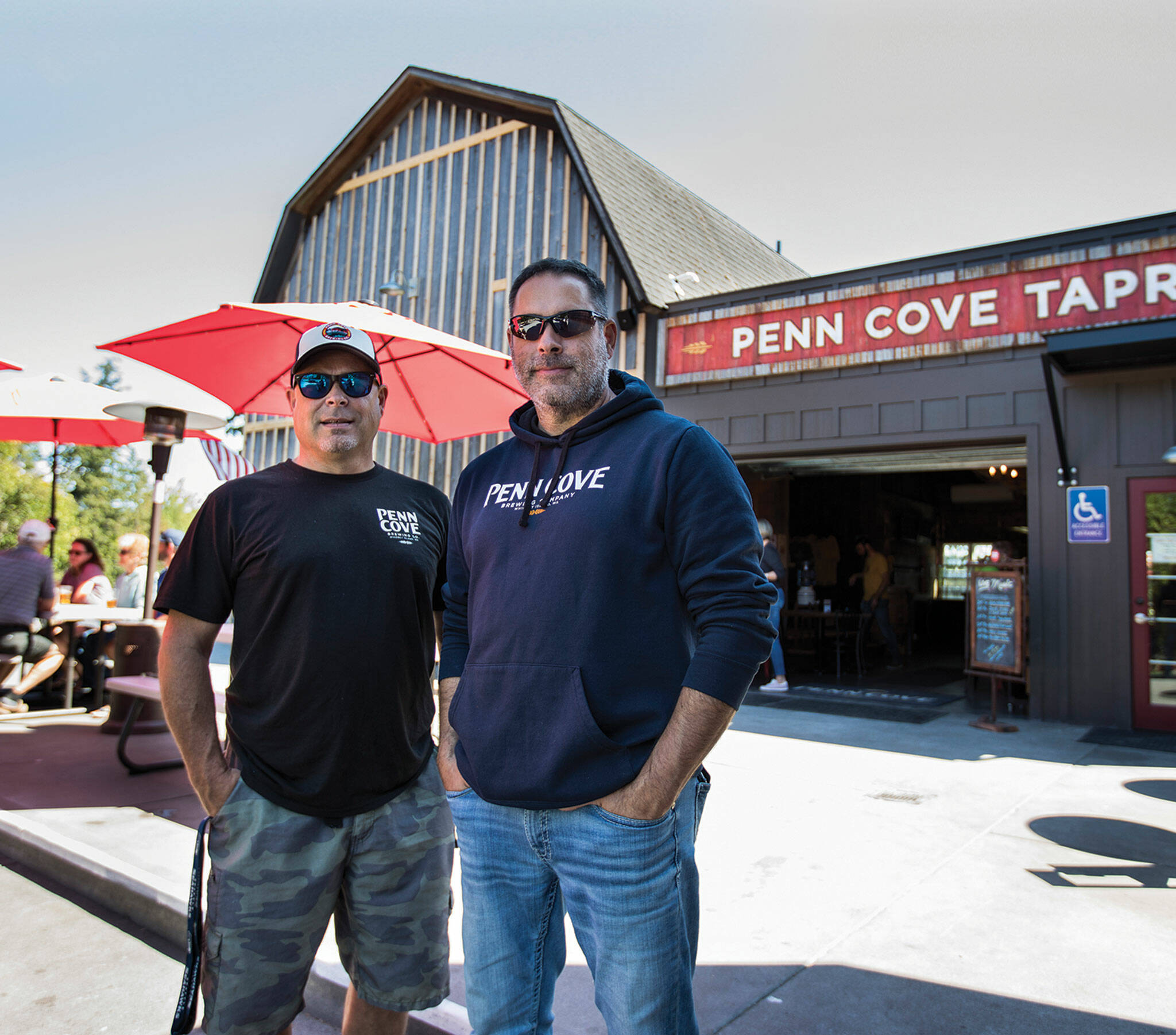 Penn Cove Brewery owners Mitch and Marc Aparicio at their new Freeland location. (Olivia Vanni / The Herald)