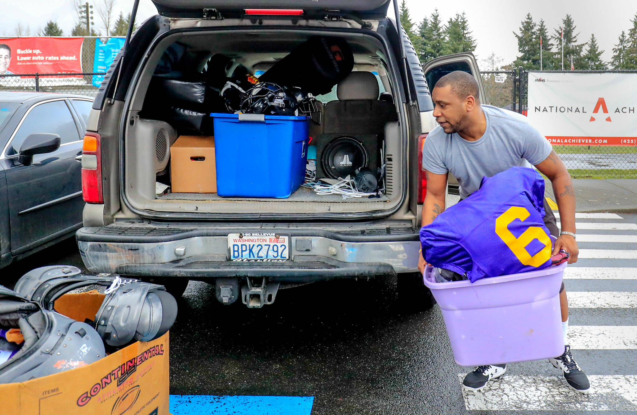 Mike Thomas packs away pads and helmets after practice at Archbishop Murphy High School in Everett. (Kevin Clark / The Herald)