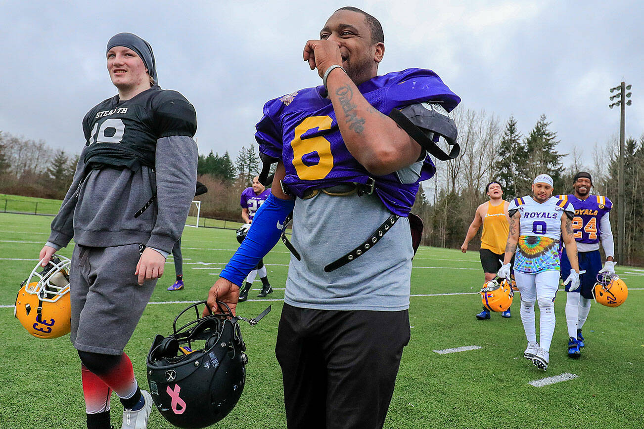 Mike Thomas (6) owner of the Everett Royals, shares a laugh after practice at Archbishop Murphy High School on February 2, 2022 in Everett, Washington. (Kevin Clark / The Herald)