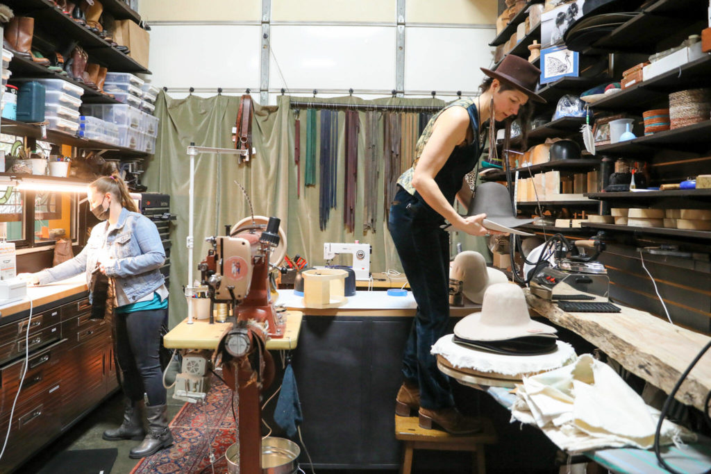 Jen Boede (left) and Jac Cash work at the manufacturing shop of FauxyFurr in Arlington. (Kevin Clark / The Herald )
