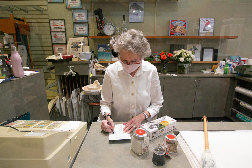 Judy Matheson tallies a customer’s purchases. (Ryan Berry / The Herald) 
