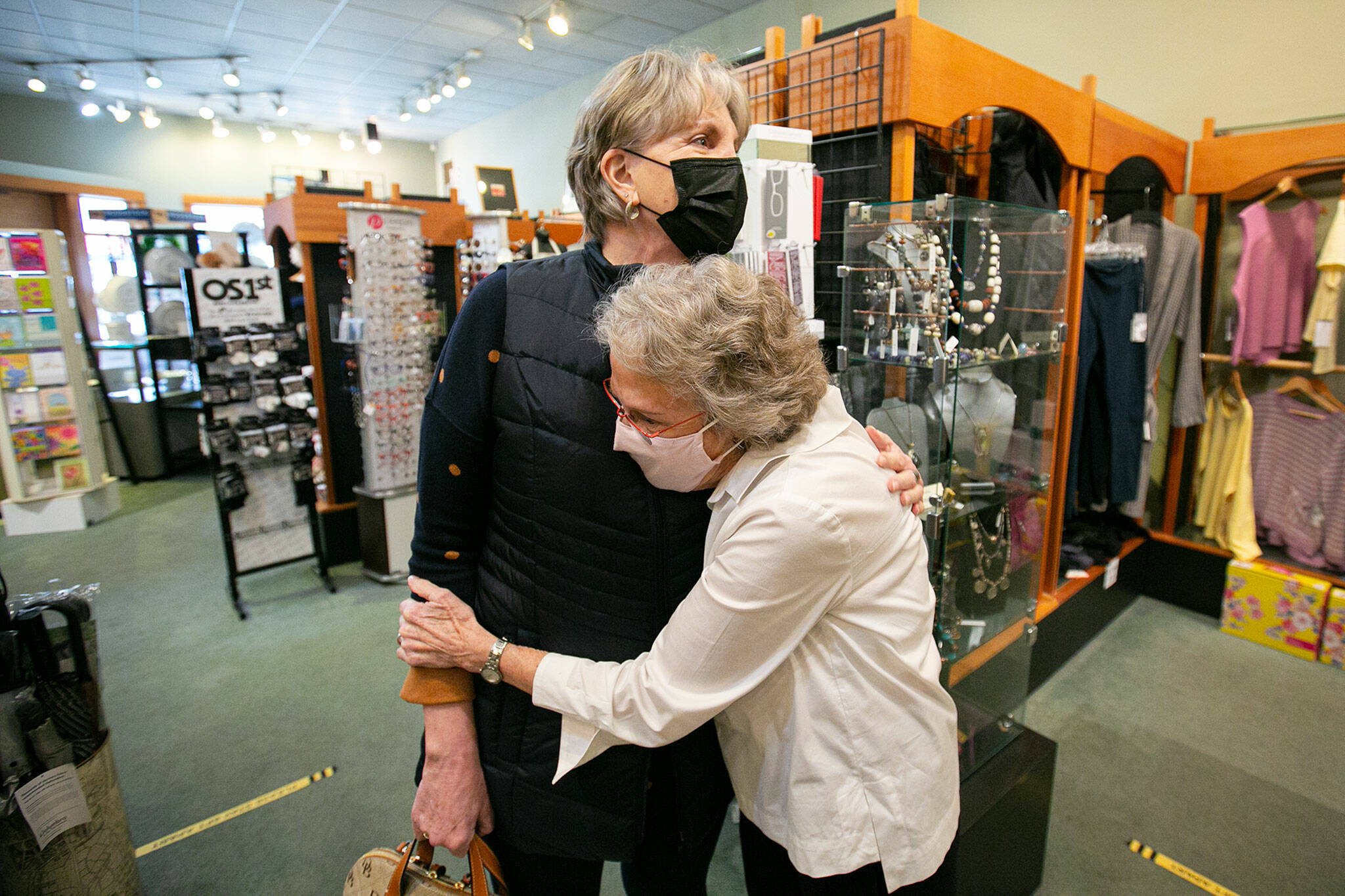 Judy Matheson hugs longtime customer Melody Taylor at J. Matheson Gifts in Everett. Matheson said she’s formed many friendships over her 31 years running the gift shop. (Ryan Berry / The Herald)