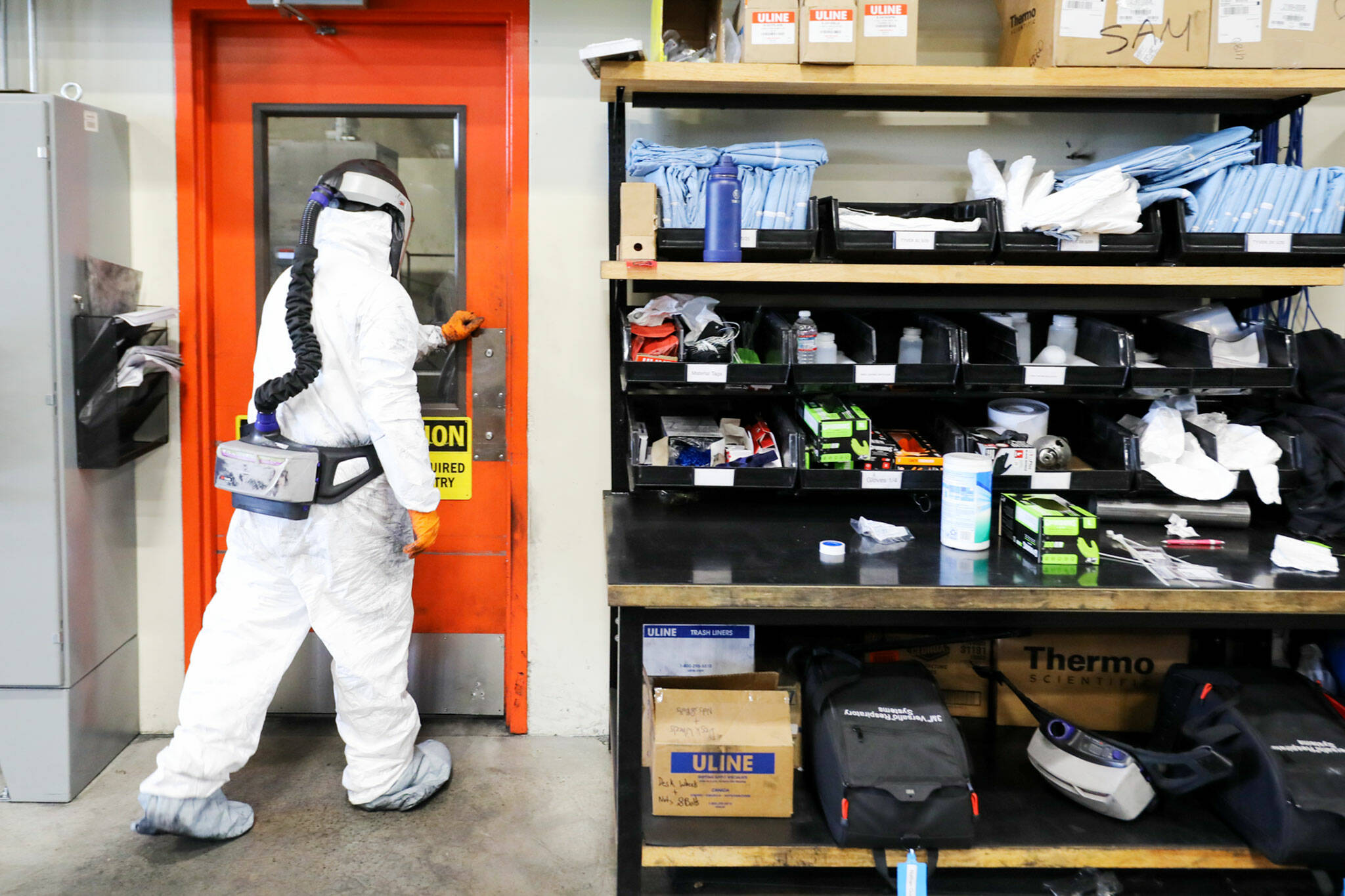 Personal protection equipment — affectionately called “space suits” — is required to enter the milling room at Group14 Technologies in Woodinville. (Kevin Clark / The Herald)