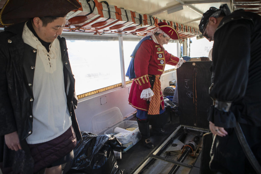 George Safadago pulls up the floor panels in the 1945 “DUKW” in Mukilteo. (Olivia Vanni / The Herald)
