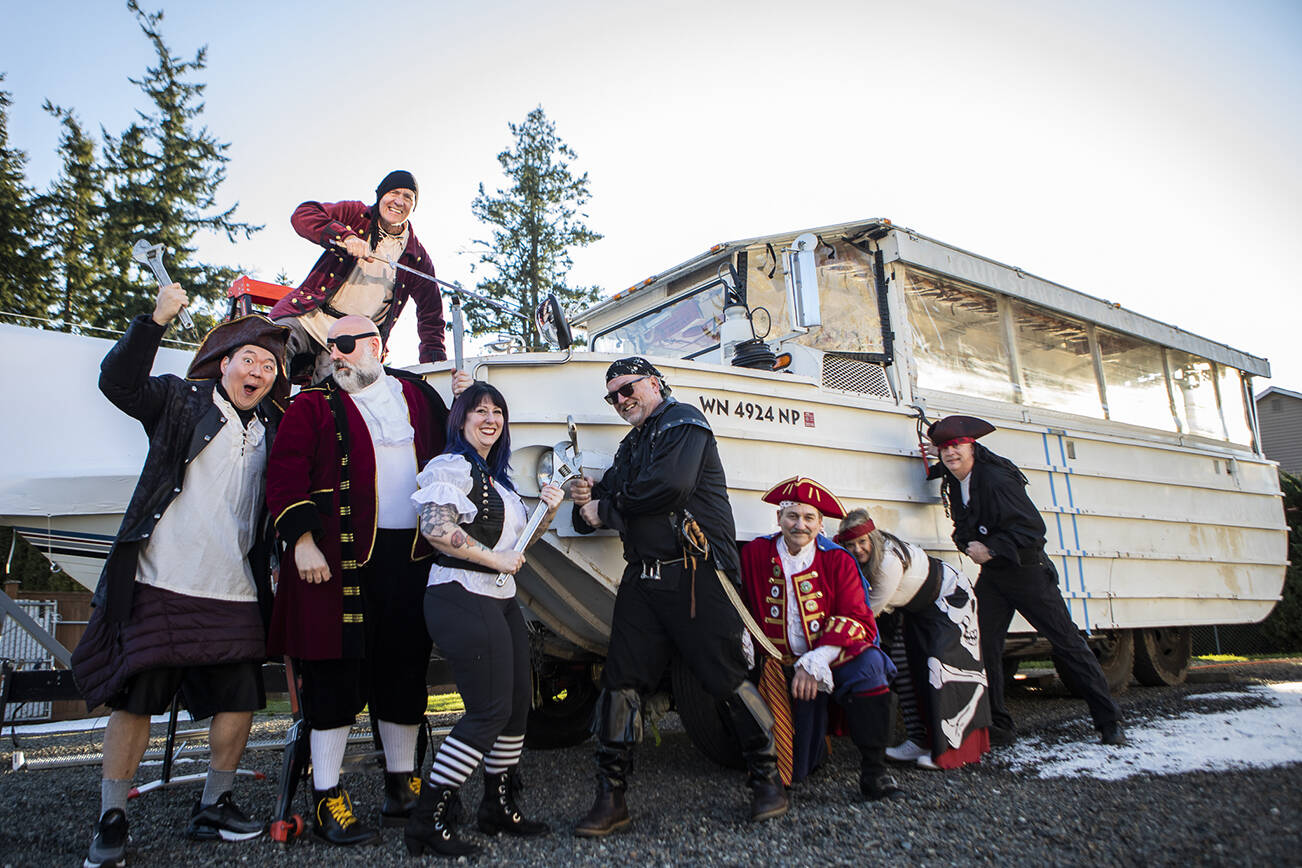 The Mukfest Pirates outside of their 1945 “DUKW“ vehicle soon to be “pirate ship” on Thursday, Feb. 24, 2022 in Mukilteo, Washington. (Olivia Vanni / The Herald)