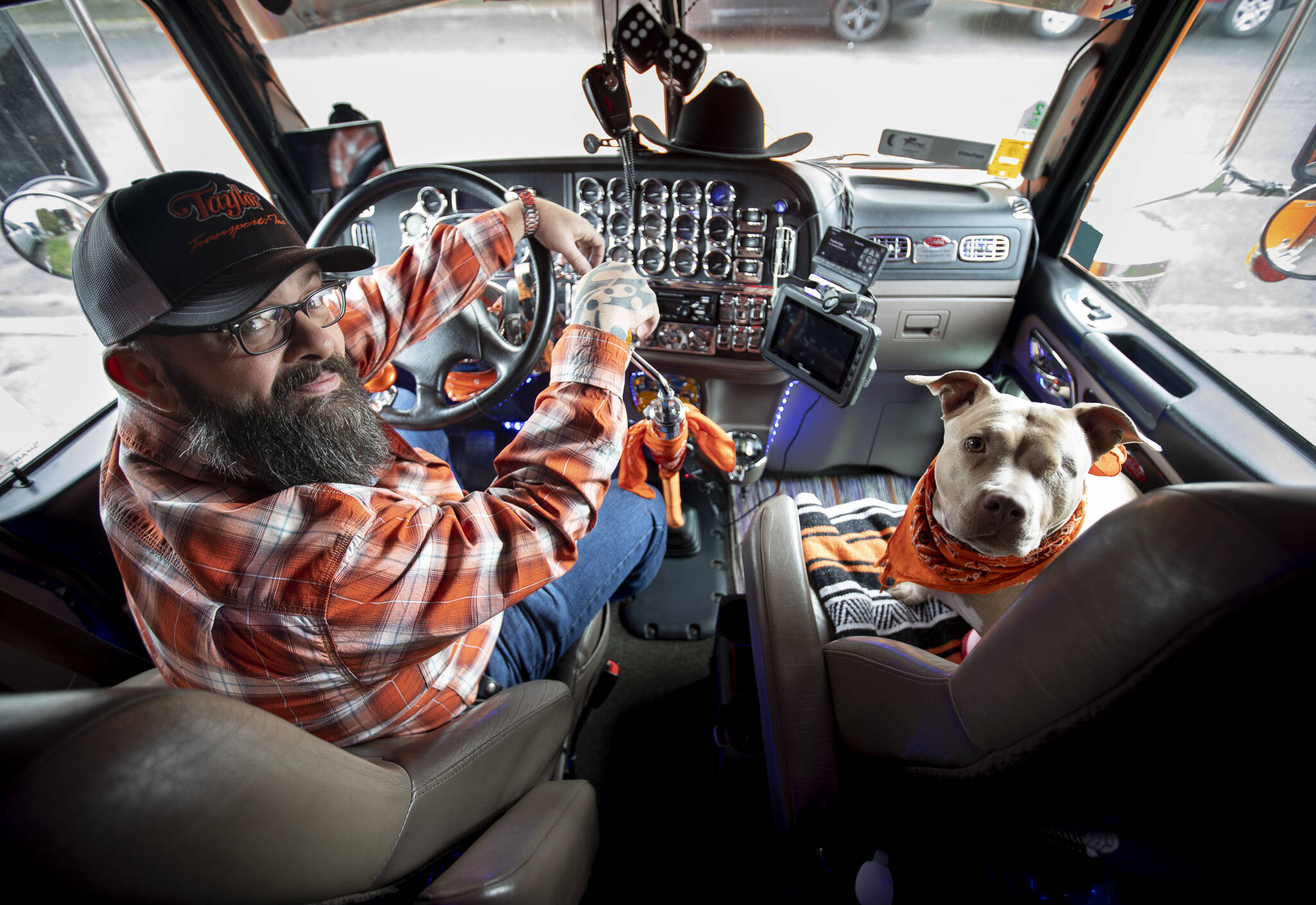 Shawn “Stogie” Dirksen and his one-eyed pitbull Bonnie inside his truck “The Orange Crush” at his home in Lake Stevens. (Olivia Vanni / The Herald)