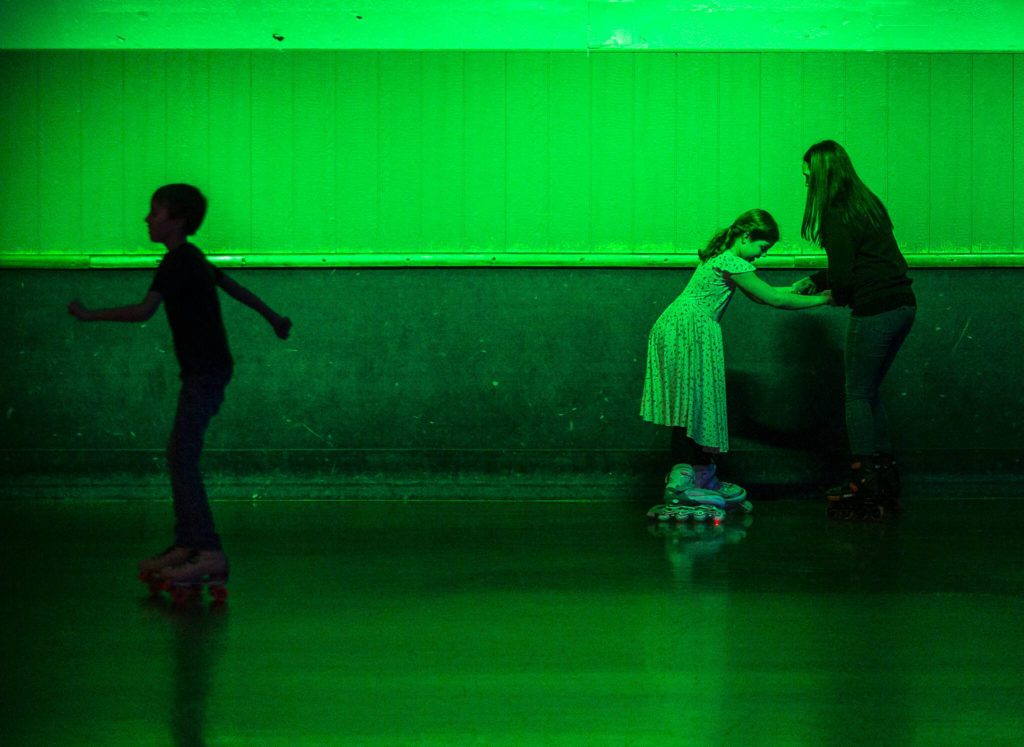 People make their way around the outer edge of the rink during family night at the Everett Skate Deck. (Olivia Vanni / The Herald)
