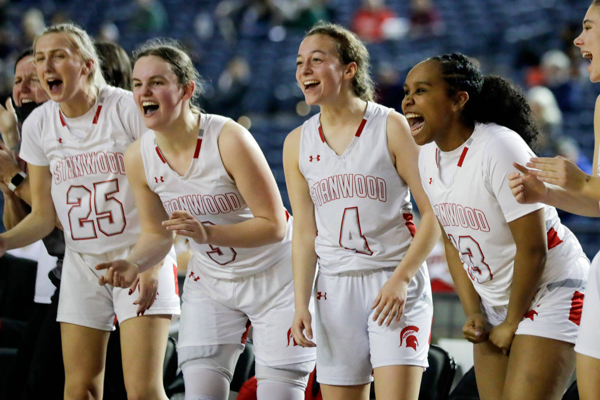 Stanwood’s bench cheers its team against Auburn on Wednesday evening in Tacoma. The Spartans advance with their 53-39 victory over the Trojans. (Kevin Clark / The Herald)