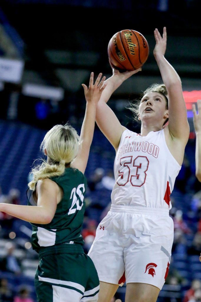 Stanwood’s Vivienne Berrett attempts a shot over Auburn’s Chloe Furnstahl on Wednesday evening in Tacoma. The Spartans advance with their 53-39 victory over the Trojans. (Kevin Clark / The Herald)
