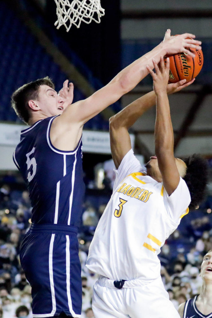 Olympia’s Mason Juergens blocks Mariner’s Jailin Johnson’s shot Wednesday afternoon in Tacoma. (Kevin Clark / The Herald)
