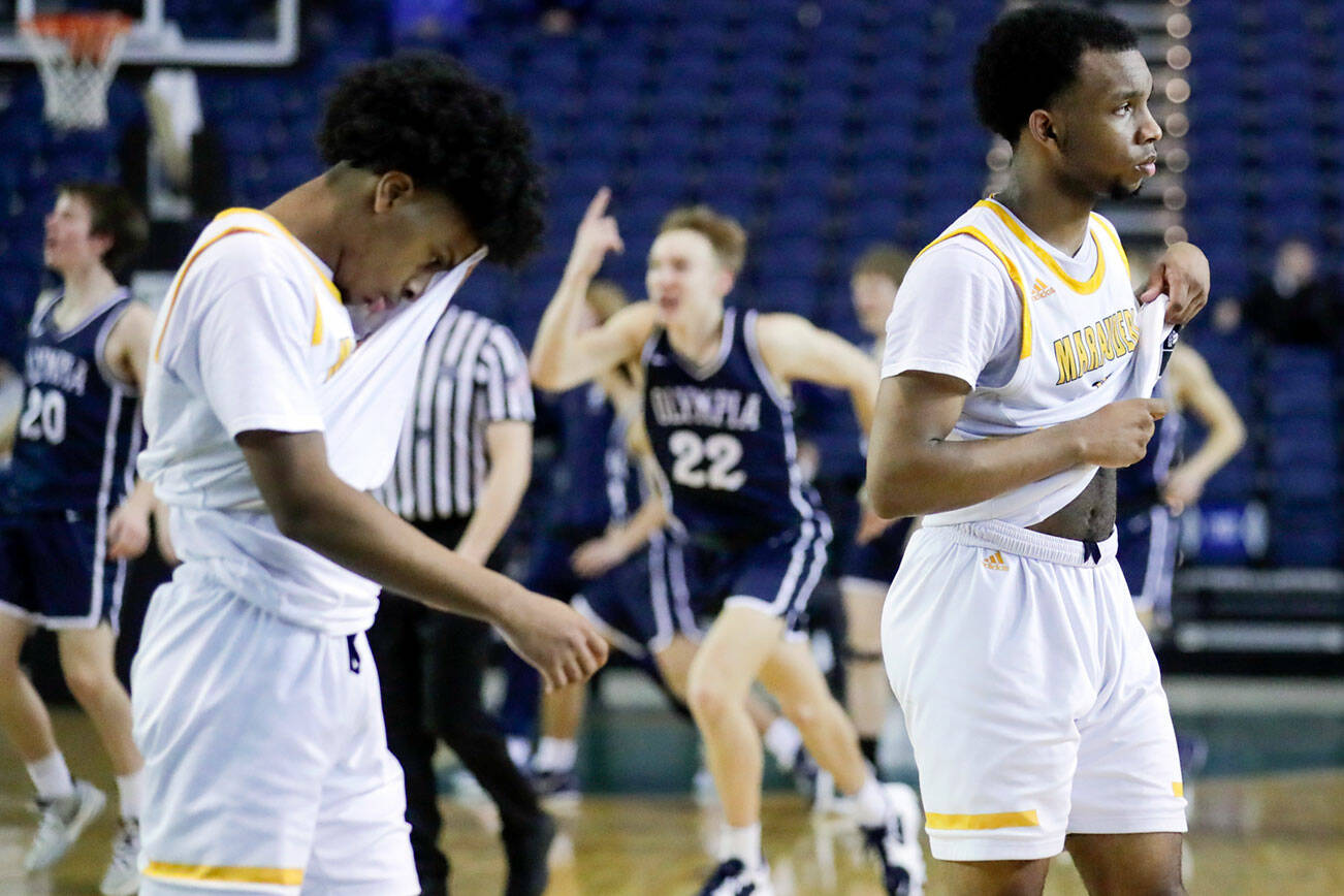 Mariner's Jailin Johnson, left, and Naser Motley walk to the bench dejected after loosing to Olympia Wednesday afternoon in Tacoma, Washington on March 2, 2022. (Kevin Clark / The Herald)