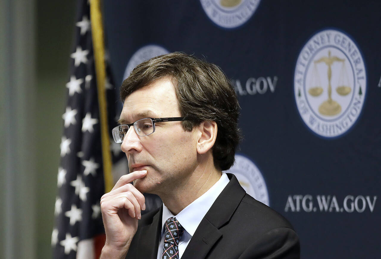 Washington state Attorney General Bob Ferguson at a news conference in Seattle in 2019. Ferguson said his office will appeal a decision by Douglas County Superior Court Judge Brian Huber to overturn a new capital gains tax on high profit stocks, bonds and other assets. (AP Photo/Elaine Thompson, File)