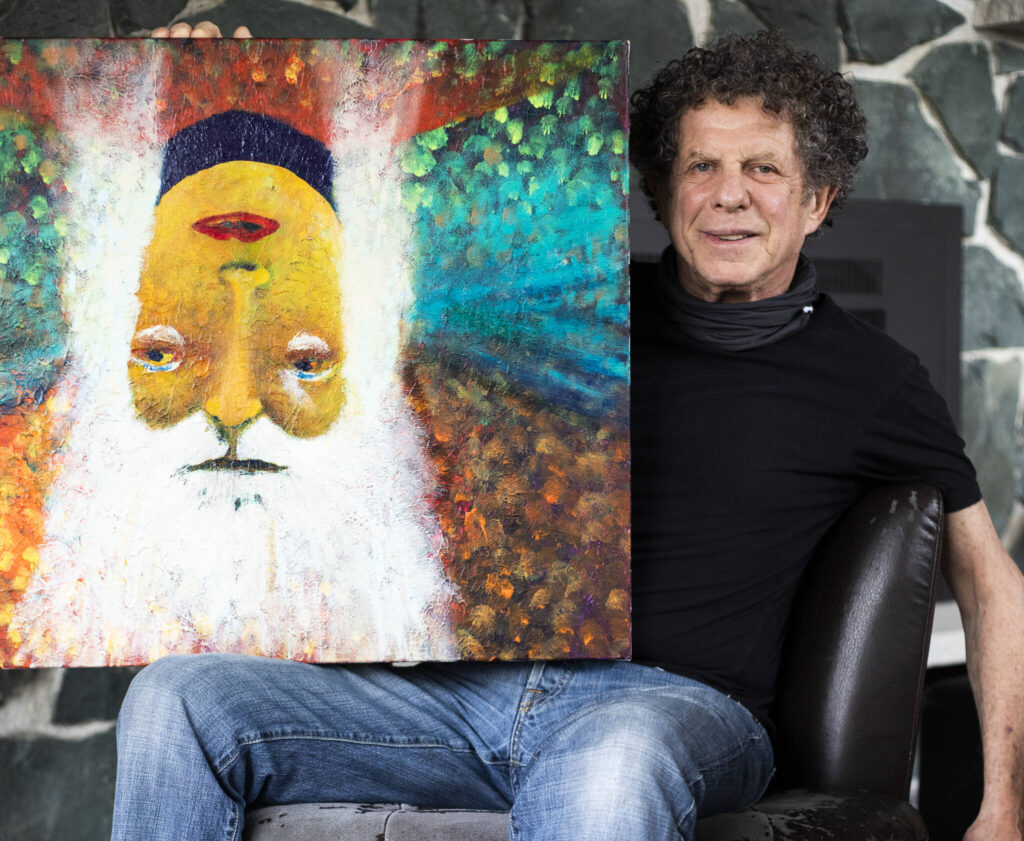 Lee Oskar with his painting that also doubles as the album artwork on his new release, “Never Forget.” (Olivia Vanni / The Herald)
