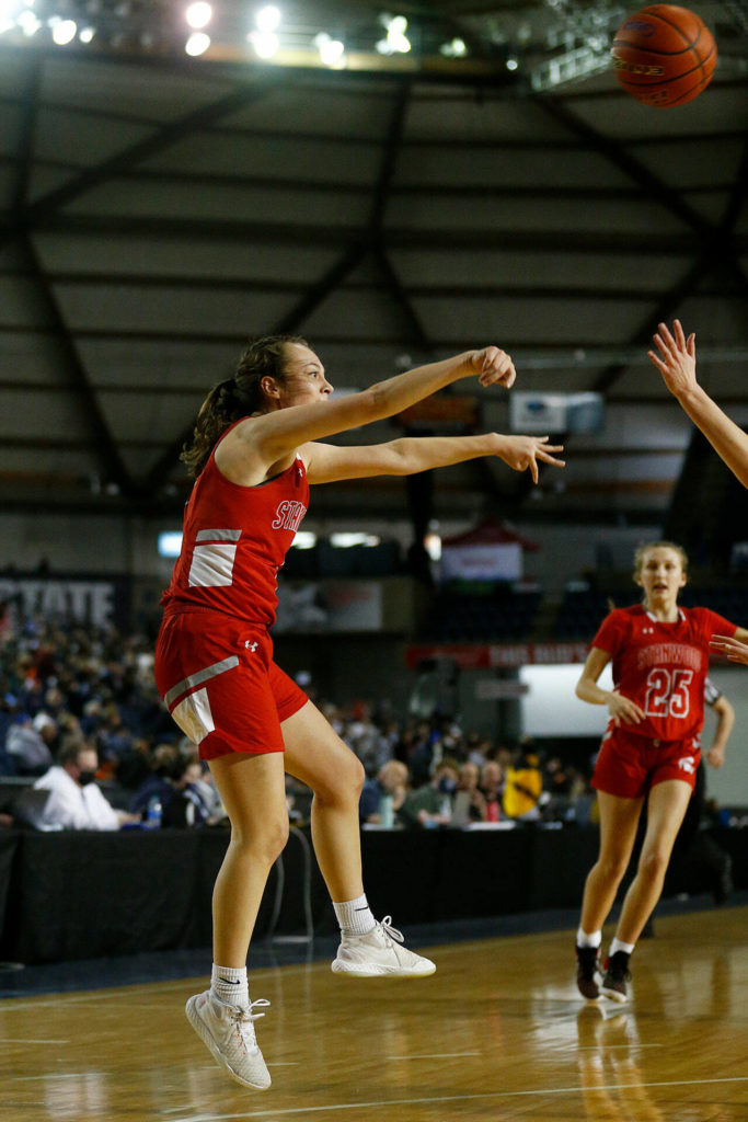 Stanwood’s Paige Almanza jumps and passes across the court against Mead on Thursday at the Tacoma Dome. (Ryan Berry / The Herald)
