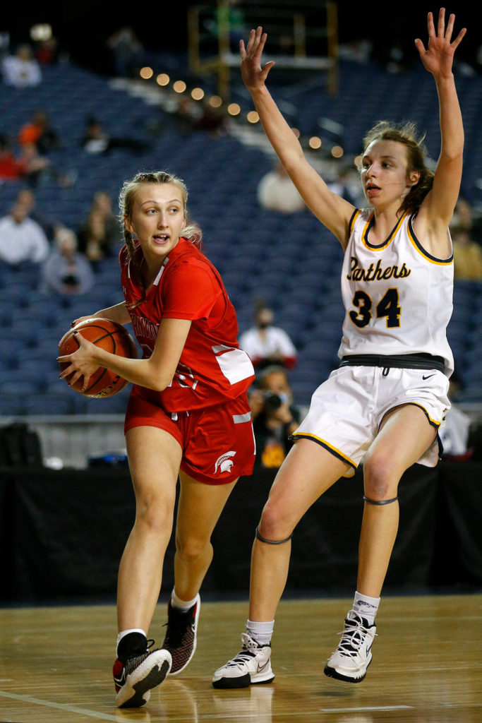 Stanwood’s Cezanne DePew takes the ball baseline before passing against Mead on Thursday at the Tacoma Dome. (Ryan Berry / The Herald)
