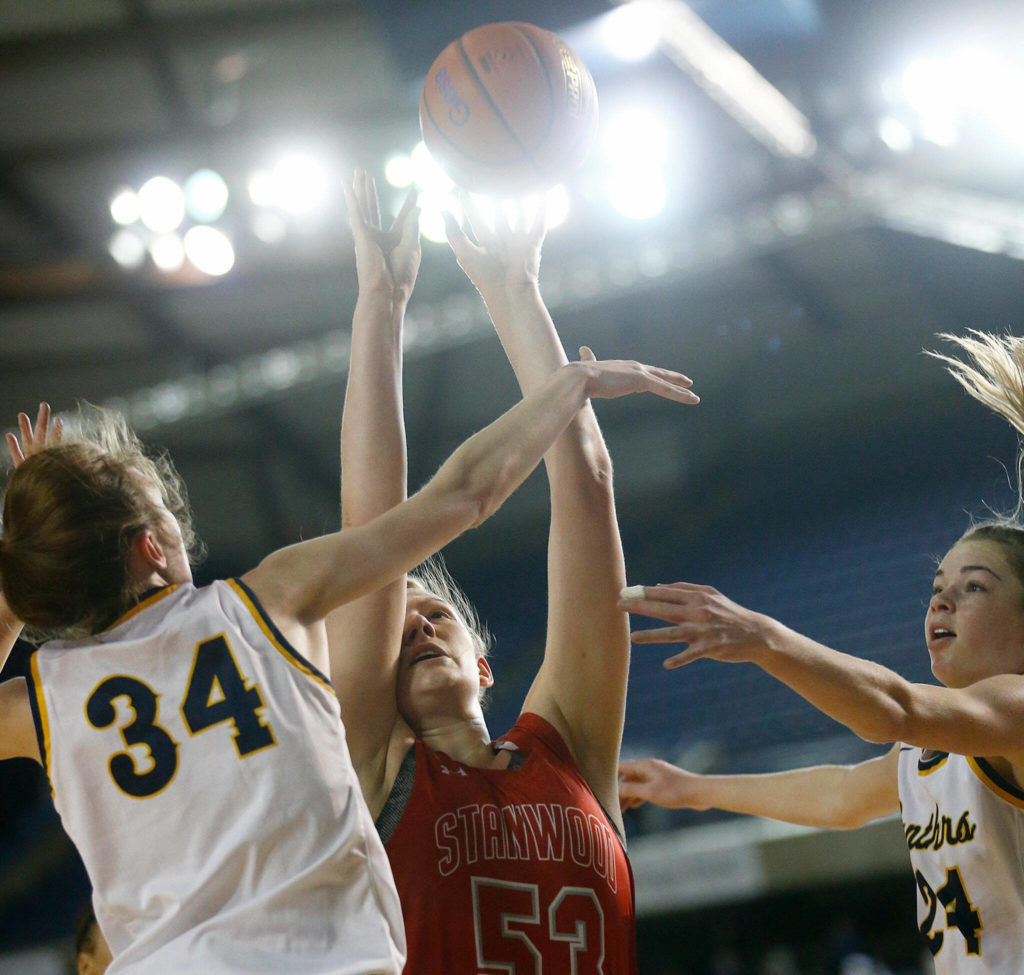 Stanwood’s Vivienne Berrett puts the ball up and in for two points against Mead on Thursday at the Tacoma Dome. (Ryan Berry / The Herald)
