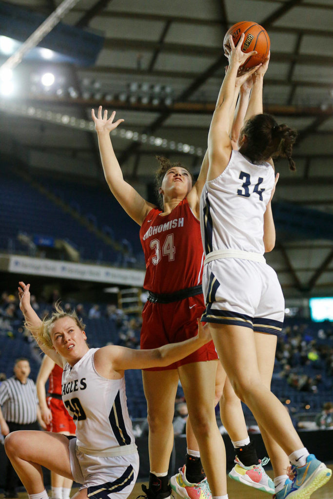 Arlington’s Jenna Villa and Snohomish’s Tyler Gildersleeve-Stiles go up for a rebound Thursday at the Tacoma Dome. (Ryan Berry / The Herald)
