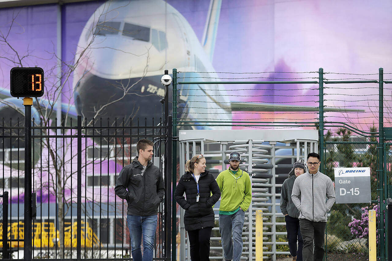 In this March 2020 photo, workers head out a gate at a Boeing airplane manufacturing plant in Renton. On Thursday, the company will pay out the final and largest round of this year’s annual bonuses. (AP Photo/Elaine Thompson, File)
