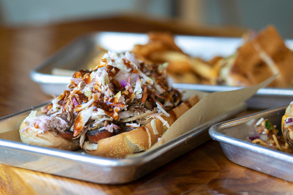 A BBQ Dog is topped with pulled pork and slaw at Meatheads Smokehouse and Beer Works in Lake Stevens. (Ryan Berry / The Herald)
