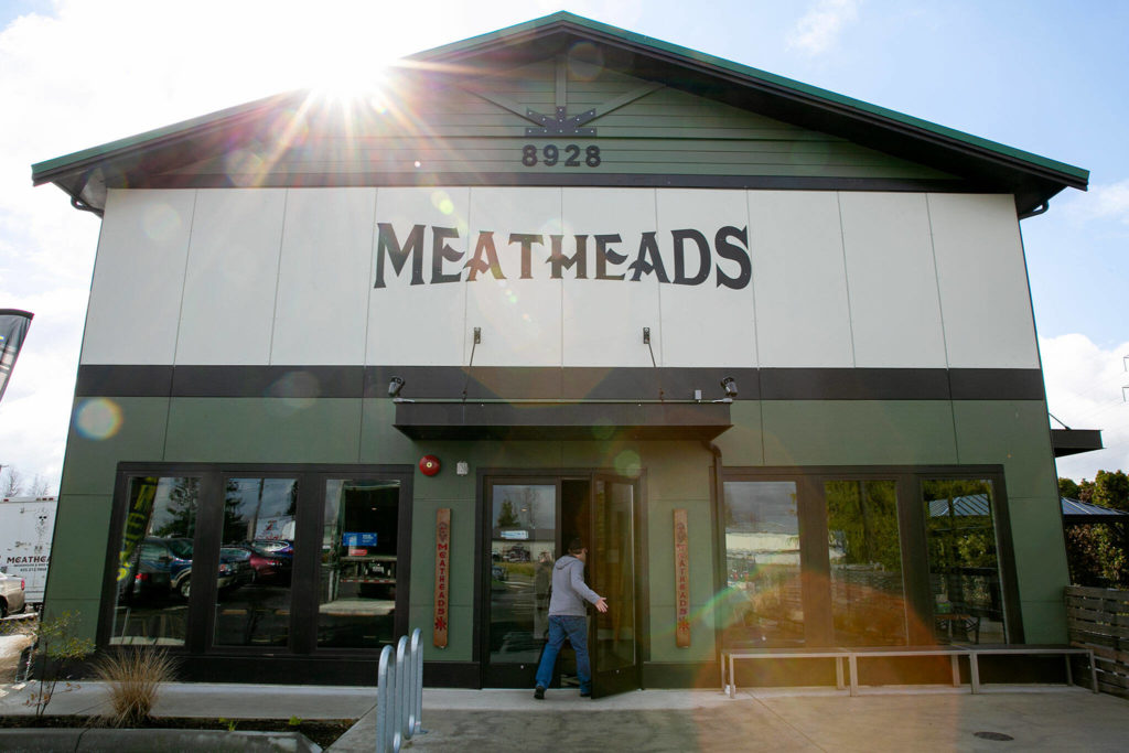 A customer enters Meatheads Smokehouse and Beer Works in Lake Stevens on Friday. (Ryan Berry / The Herald)
