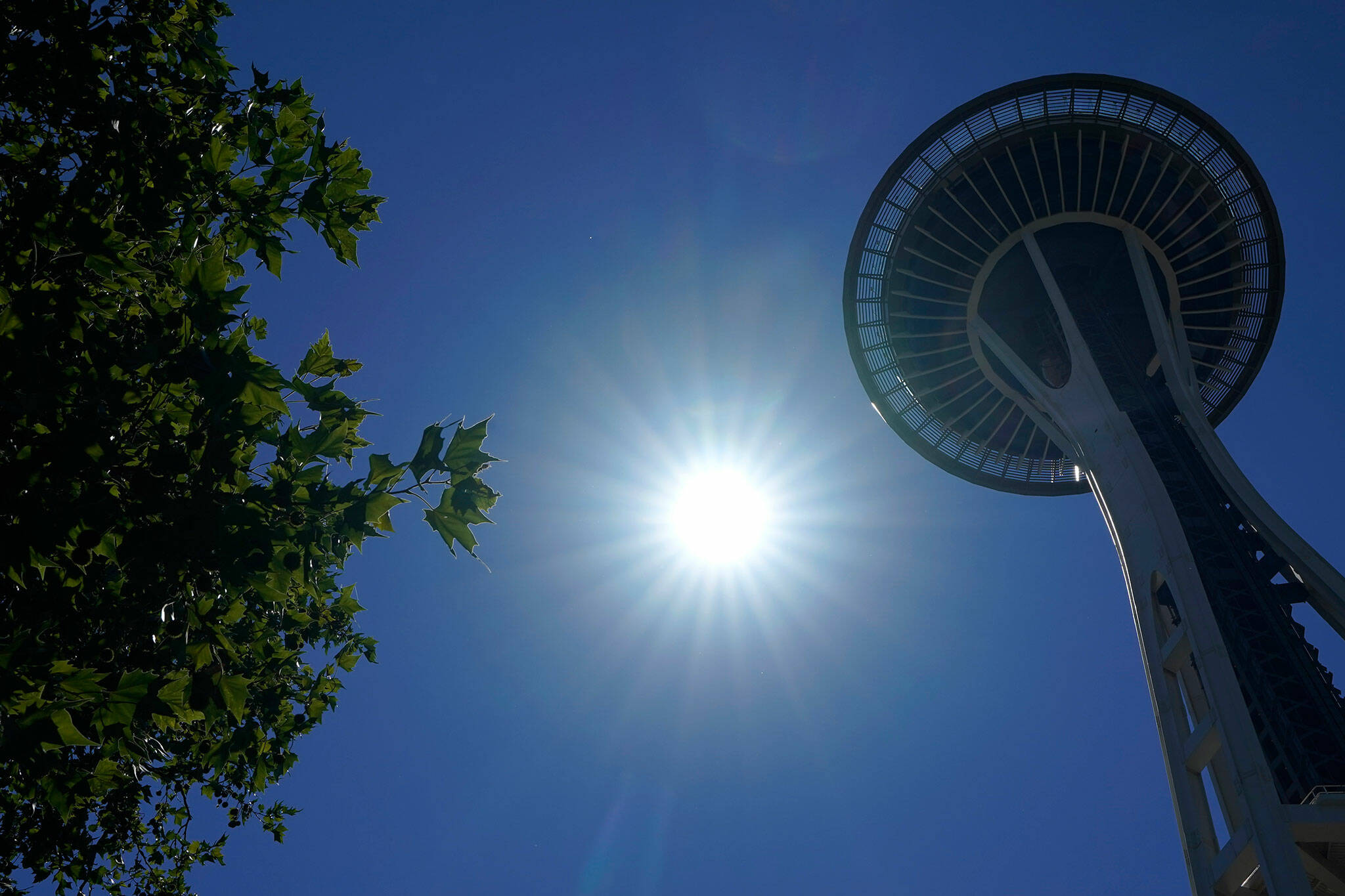 The sun shines near the Space Needle, June 28, 2021, in Seattle as Northwest cities broke all-time heat records, with temperatures soaring well above 100 degrees Fahrenheit. Weather extremes like this will increase in frequency and intensity in North America the coming years as global warming accelerates, according to a United Nations Intergovernmental Panel on Climate Change report released last week. (Ted S. Warren / Associated Press)