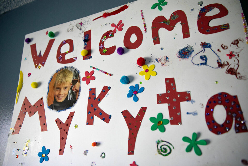 A welcome sign, made by his foster sisters, hangs on the wall in Mykyta’s bedroom on Sunday in Snohomish. (Ryan Berry / The Herald)
