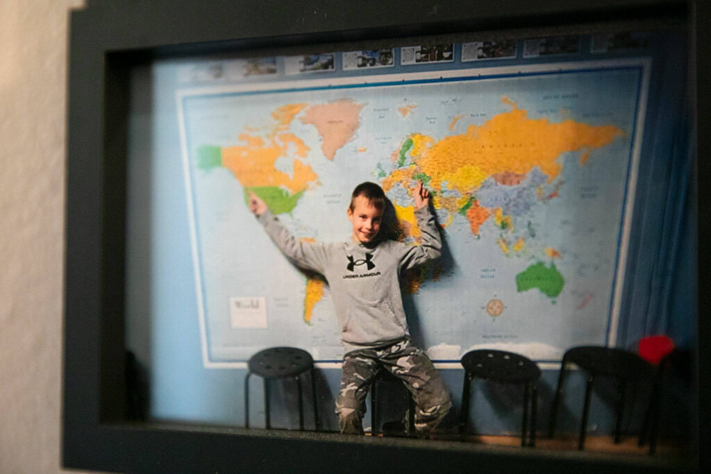 A photo of Mykyta pointing to his two homes, Ukraine and Washington, hangs on the wall outside his bedroom.
