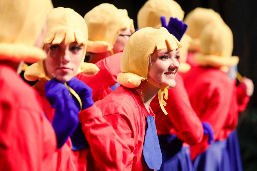 A line of Duloc citizens line up for a custom review during a dress rehearsal of Shrek the Musical at Byrnes Performing Arts Center in Arlington on Feb. 26. Final performances by Arlington High School students are March 11 at 7 p.m. and March 12 at 1 p.m. and 7 p.m (Kevin Clark / The Herald)
