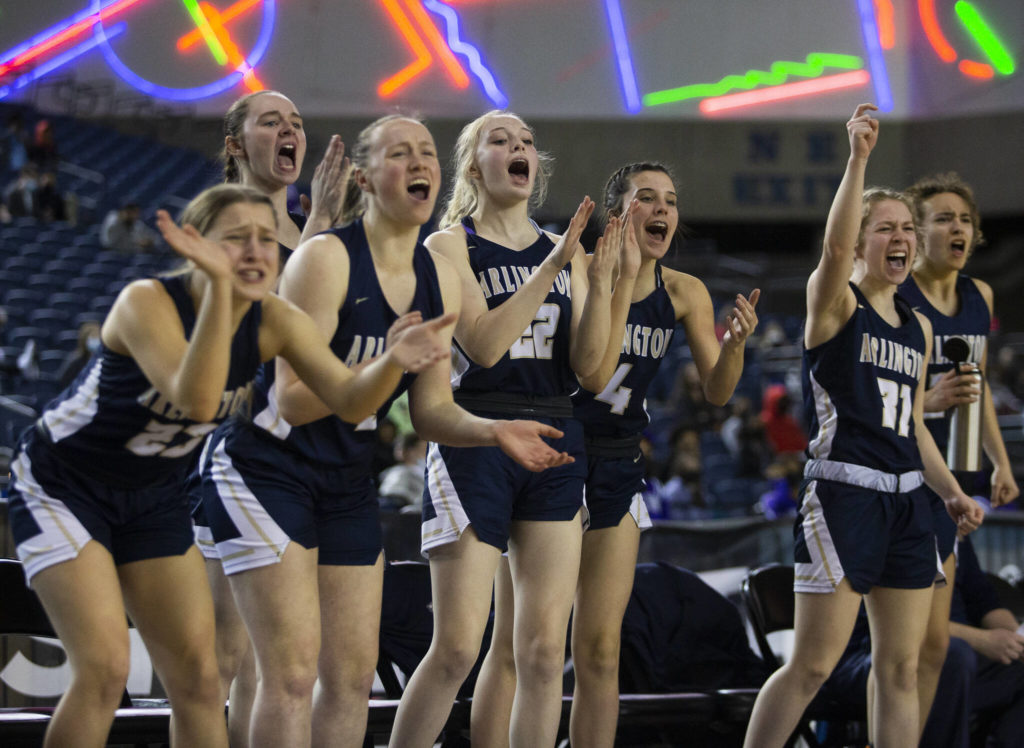 The Arlington bench reacts to a three-point shot during the 3A state semifinal against Garfield at the Tacoma Dome on Friday, March 4, 2022. (Olivia Vanni / The Herald)
