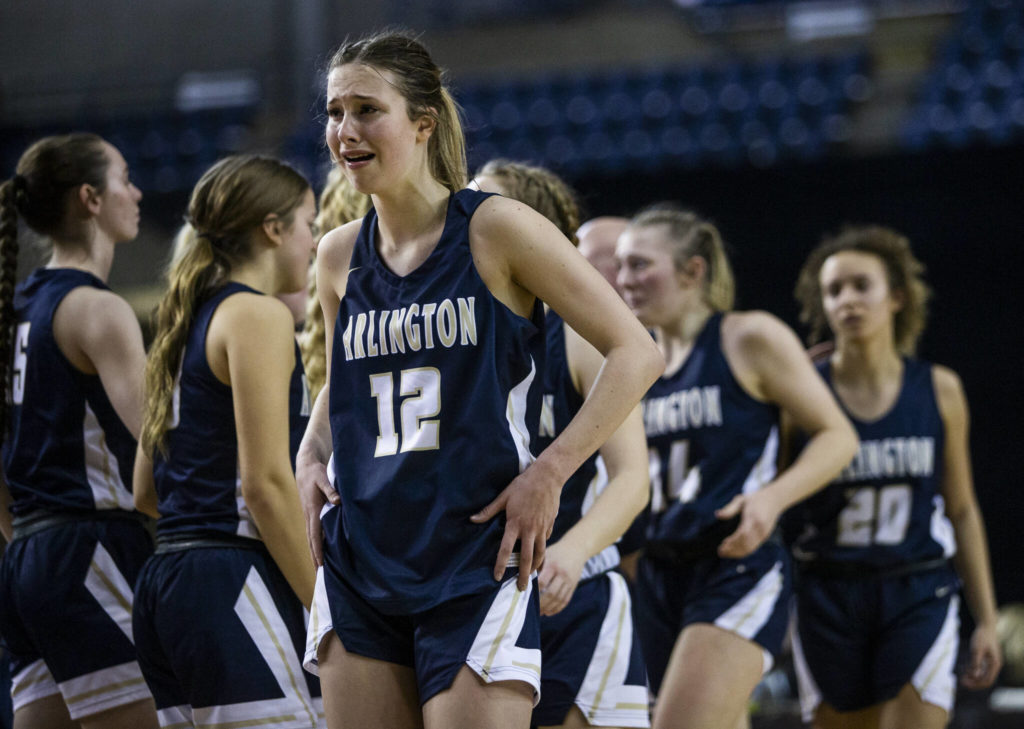 Arlington’s Hannah Rork cries after losing to Garfield in the 3A state semifinal at the Tacoma Dome on Friday, March 4, 2022. (Olivia Vanni / The Herald)
