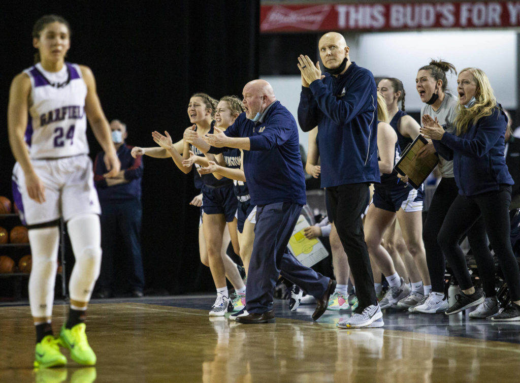 The Arlington bench reacts to pulling ahead of Garfield during the first quarter of the 3A state semifinal at the Tacoma Dome on Friday, March 4, 2022. (Olivia Vanni / The Herald)
