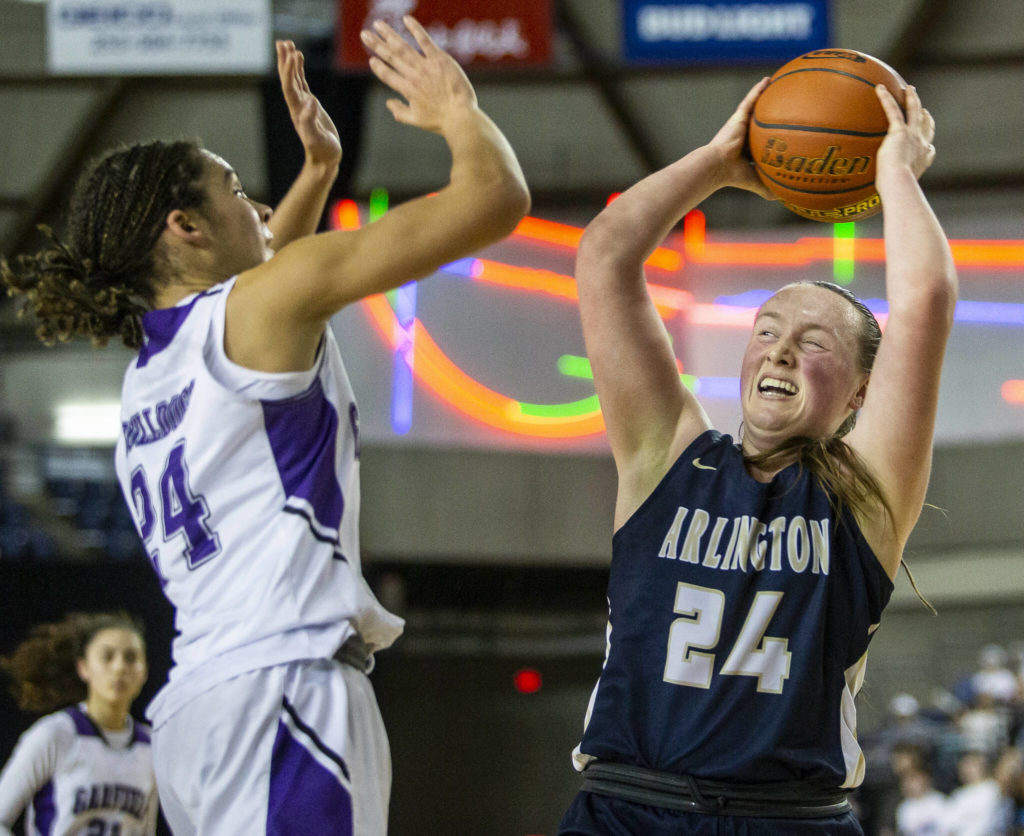 Arlington’s Katie Snow rebounds the ball during the 3A state semifinal against Garfield at the Tacoma Dome on Friday, March 4, 2022. (Olivia Vanni / The Herald)
