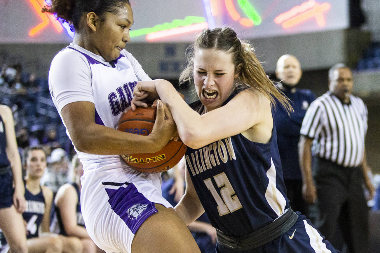 Arlington's Hannah Rork struggles to grab the ball from Garfield's Malia Samuels during the 3A state semifinal at the Tacoma Dome on Friday, March 4, 2022. (Olivia Vanni / The Herald)