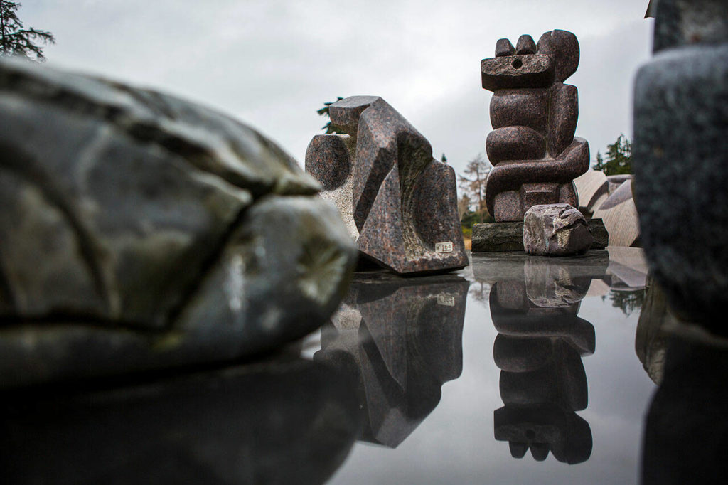 A sculpture is reflected off of a smooth surface at the Cloudstone Sculpture outdoor gallery in Freeland on Whidbey Island. (Olivia Vanni / Herald file)
