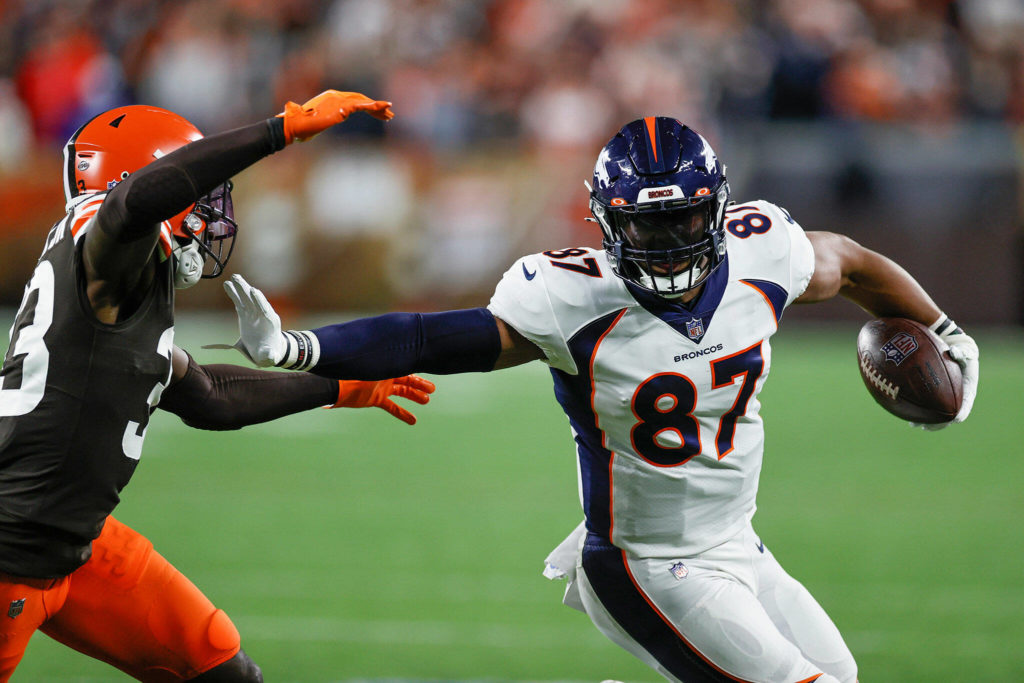 Broncos tight end Noah Fant (87) fends off Browns defensive back Ronnie Harrison (33) during the second half of a game Oct. 21, 2021, in Cleveland. (AP Photo/Ron Schwane)
