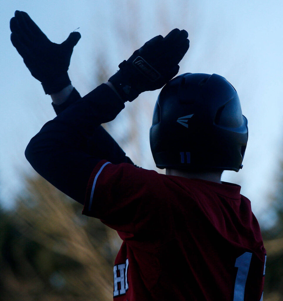 Archbishop Murphy’s Jacob Shaw claps after getting his team to within a run with a fielder’s choice during a jamboree game against Seattle Prep Wednesday, March 9, 2022, in Everett, Washington. (Ryan Berry / The Herald)
